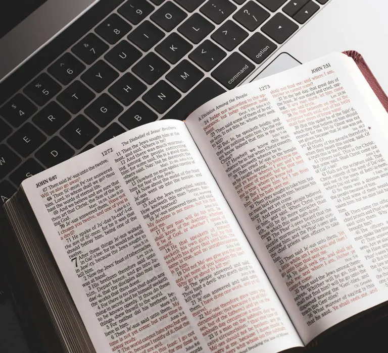 Bible laying open on laptop