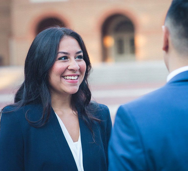 Regent University student talking to another student