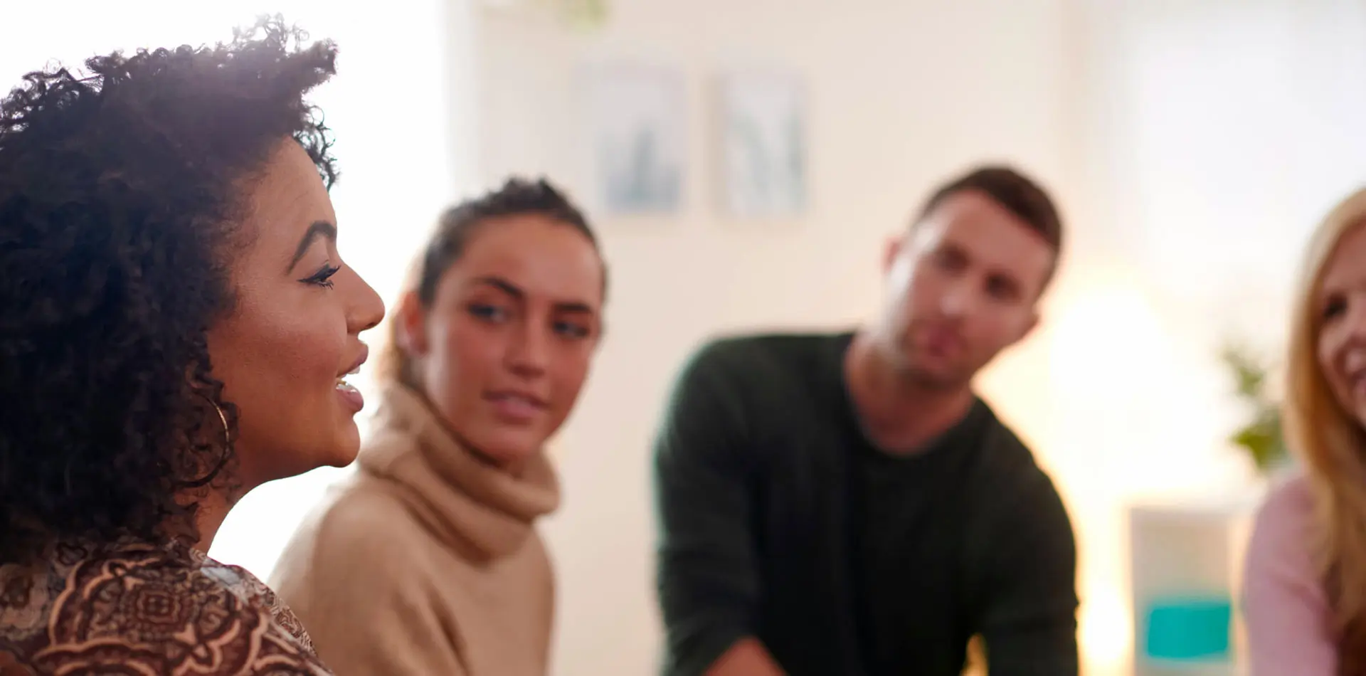 Woman speaking with group at table