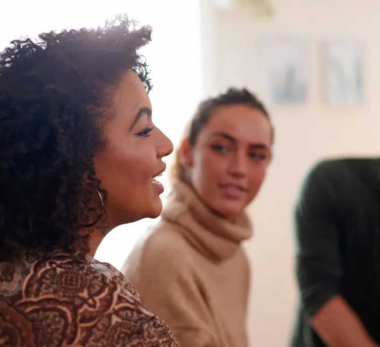 Woman speaking with group at table