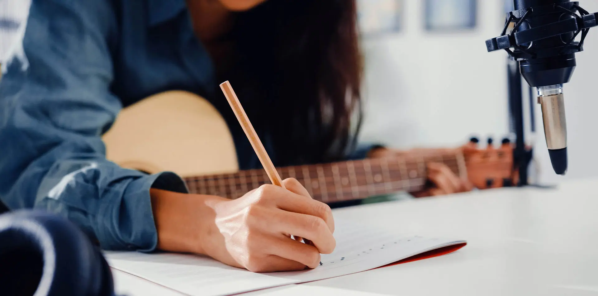 Regent student writing a song with guitar